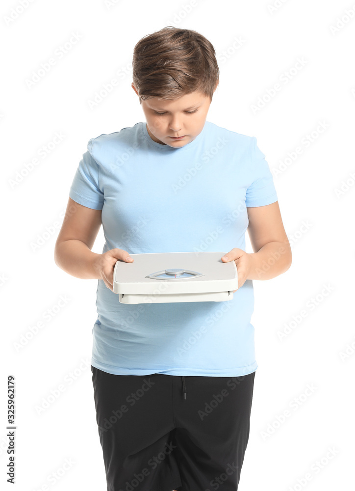 Overweight boy with scales on white background