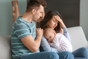 Canvas Print - Young father with baby and wife suffering from postnatal depression at home