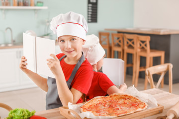 Canvas Print - Cute little chefs with cook books in kitchen