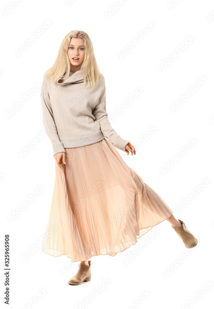 Beautiful young woman in warm sweater on white background
