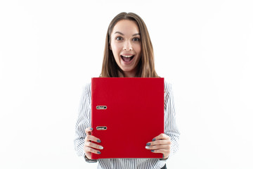Wall Mural - Portrait of a girl in an office dress code with a red folder on a white background. Emotional girl
