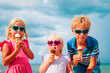 © nadezhda1906 - happy kids- boy and girls- eating ice cream on beach