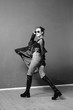 © Oleg Samoylov - Black and white fashion shot. Portrait of a fashionable girl in high boots, a long coat, jeans and sunglasses.