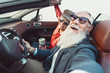 © Alessandro Biascioli - Happy senior couple taking selfie on new convertible car - Mature people having fun together during road trip vacation - Elderly lifestyle and travel transportation concept