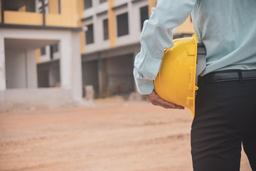 Wall Mural - Businessman holding hard hat building estate construction background,Engineer Supervisor  Foreman concept