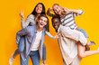 © Prostock-studio - Two international teen couples having fun over yellow background