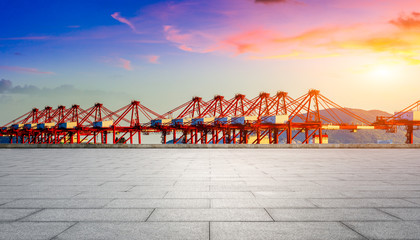 Empty floor and industrial container freight port at beautiful sunset in Shanghai.