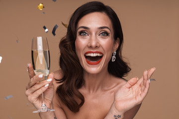 Beauty portrait of excited adult half-naked woman holding champagne glass