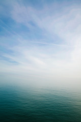 scenic view of sky and sea blending into a misty white horizon