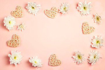 Poster - Frame of chrysanthemums and decorative hearts on a pink background.