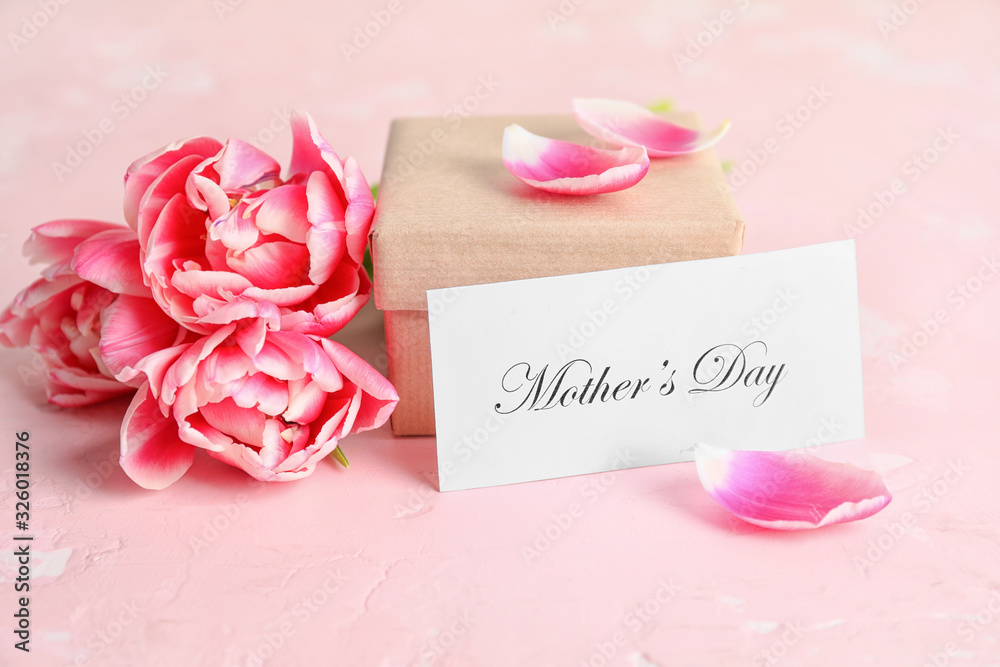 Beautiful flowers, gift and card for Mother's Day on table