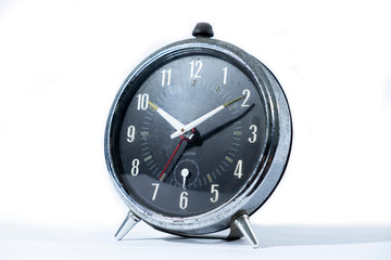 Classic style black table clock isolated on a white background.