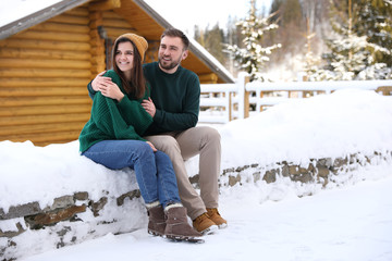 Sticker - Lovely couple spending time together on snowy day. Winter vacation