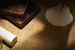 © raland - Seashell, scroll and old books on the table. Symbol of the pilgrimage journey to Santiago de Compostela.  Camino de Santiago in Spain. Copy space.