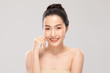 © 220 Selfmade studio - Beautiful Asian young woman touching soft cheek smile with clean and fresh skin Happiness and cheerful with positive emotional,isolated on white background,Beauty and Cosmetics Concept