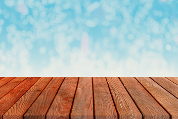 Empty Perspective Brown Weathered Wood Planks - Wooden Table on Bright Blurred Blue Background Mock Up for Product Placement