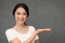Successful Girl Pointing Suggesting Hand Up; Portrait Of Cheerful Smiling Woman Pointing Up Approving, Yes, Ok, Good, Recommendation Hand Up Gesture; Chinese Or East Asian Woman Young Adult Model