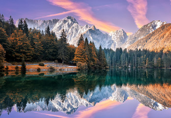 Aufkleber - Impressive Autumn landscape during sunset.  The Fusine Lake in front of the Mongart under sunlight. Amazing sunny day on the mountain lake. concept of an ideal resting place. Creative image.