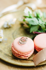 Canvas Print - Wedding rings on a macaroon cakes as decoration