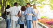 © Prostock-studio - Group of friends hugging and walking by public park