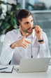 © LIGHTFIELD STUDIOS - handsome male translator working online with headset and laptop