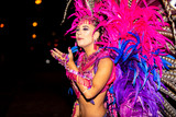 Brazilian wearing Samba Costume. Beautiful Brazilian woman wearing colorful costume and smiling during Carnaval street parade in Brazil.