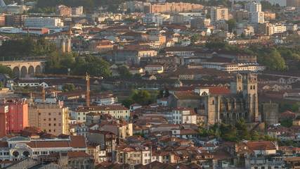 Wall Mural - Rooftops of Porto's old town on a warm spring day timelapse before sunset, Porto, Portugal