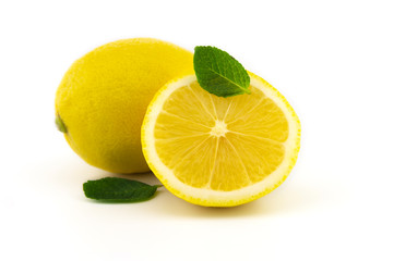 Whole and half sliced lemon and mint leaves