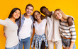 © Prostock-studio - Friendly international group of teenagers taking selfie over yellow background