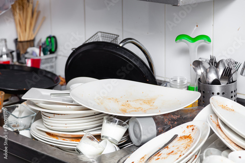 Fotografía Metal sink full of dirty dishes, crockery, tableware