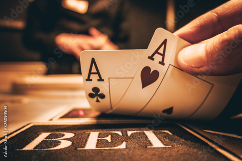 Dealer or croupier shuffles poker cards in a casino on the background of a table, chips Poster Mural XXL