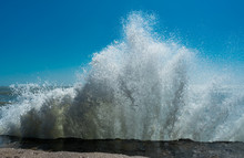 Water Splash Of Powerful Waves On Blue Sky Background. Sea Foam Crashing Close Up , Huge Waves. Water Texture.