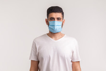 Protection Against Contagious Disease, Coronavirus. Man Wearing Hygienic Mask To Prevent Infection, Airborne Respiratory Illness Such As Flu, 2019-nCoV. Indoor Studio Shot Isolated On White Background