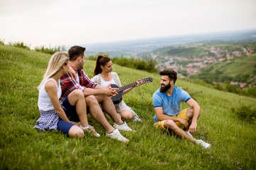 Group od young people having fun on a field trip in nature on a mountain