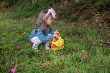 Wall Mural - Girl with bunny ears collects the eggs for Easter