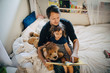 © Maskot - High angle view of father reading book with daughter while sitting in bedroom