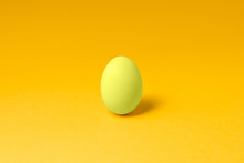 One Pastel Yellow Color Egg In Center On Yellow Background Easter Concept Design