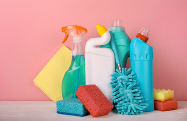 Set of cleaning products on pink background