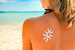 © Kostia - happy girl on the sea with a picture of the sun on her back