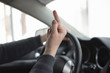 © Dmitriy - Angry driver is showing an obscene gesture close up.