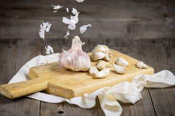 Still life with garlics on rustic wood table .