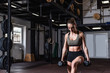 © Srdjan - Young strong fit muscular sweaty girl with big muscles strength one leg squat crossfit workout training with dumbbells weights in the gym real people exercise