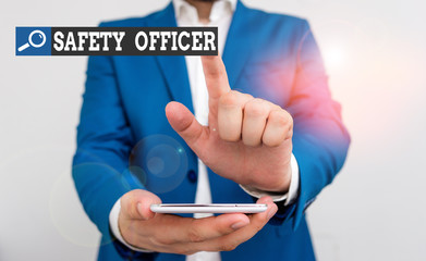 Poster - Conceptual hand writing showing Safety Officer. Concept meaning a demonstrating responsible for ensuring safety regulations Businessman in the blue suite with lap top pointing with finger