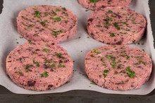 Raw Veggie Burger With Beetroot And White Beans With Parsley Leaves On Wood Cutting Board.