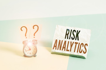 Poster - Writing note showing Risk Analytics. Business concept for study of underlying uncertainty of a given course of action Alarm clock beside a Paper sheet placed on pastel backdrop