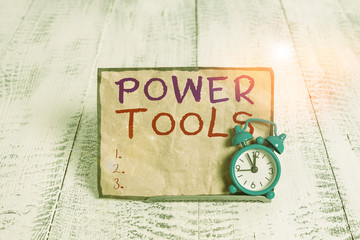Poster - Word writing text Power Tools. Business photo showcasing tool that is actuated by additional power source and mechanism Mini blue alarm clock stand tilted above buffer wire in front of notepaper