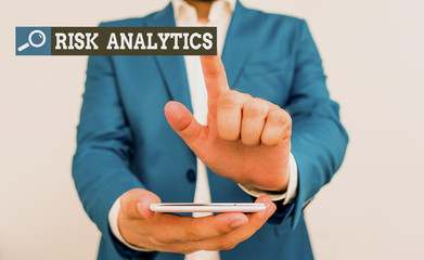 Poster - Conceptual hand writing showing Risk Analytics. Concept meaning study of underlying uncertainty of a given course of action Businessman in the blue suite with lap top pointing with finger