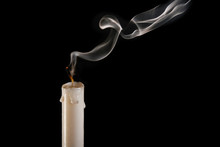 An Extinguished Candle On A Black Background, Smoke Goes From The Wick To The Top. The Concept Of Completeness And Completeness.