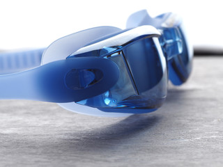 Professional Blue glasses for swimming on a gray background