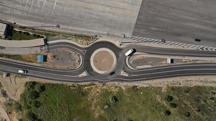 Canvas Print - Aerial drone top view of circular roundabout junction leading to multiple directions part of National road